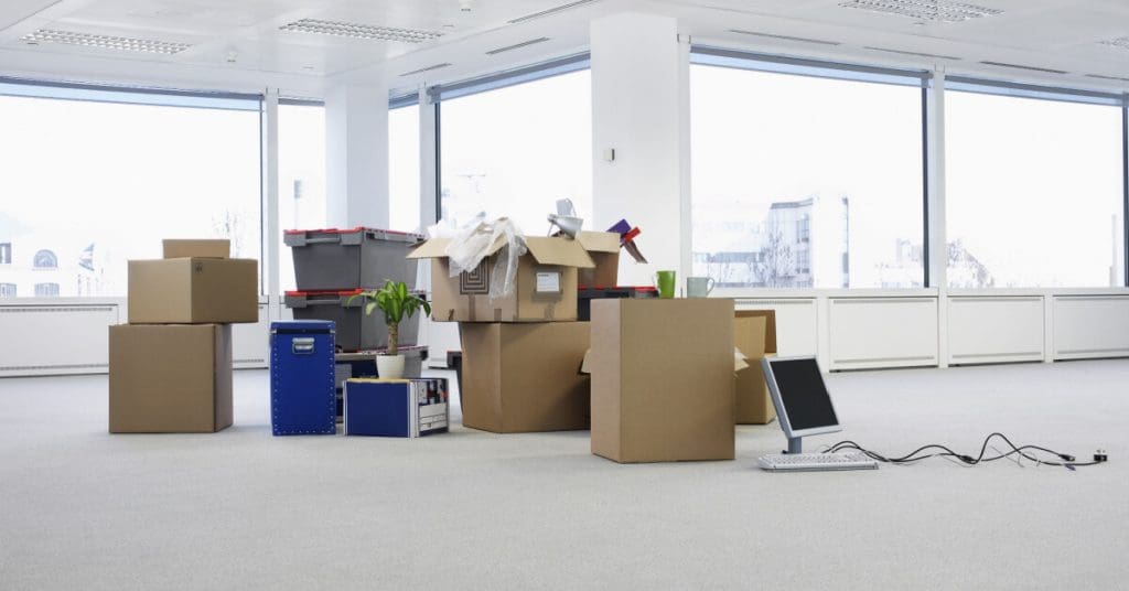 Cartons and equipment on floor of empty office space